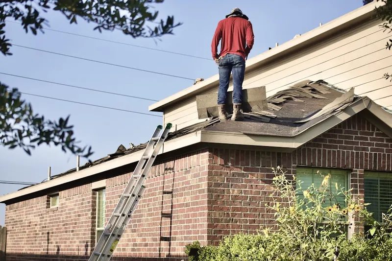 Professional roofer working on a residential roof in Lake Park
